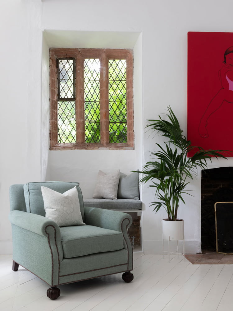 Green armchair in white room