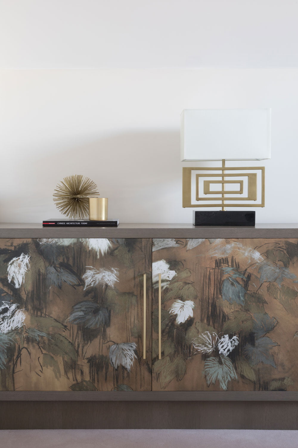 Mantelpiece decor with lamp and asian inspired cupboards