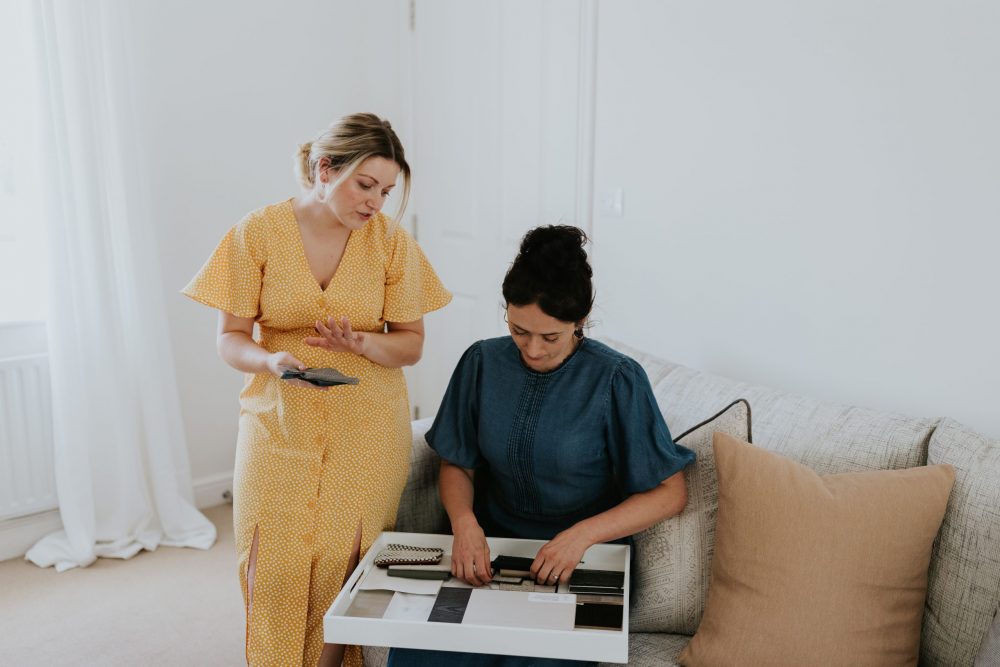 Danielle & Emily Looking at Material Swatches - Wells and Maguire Interior Designers