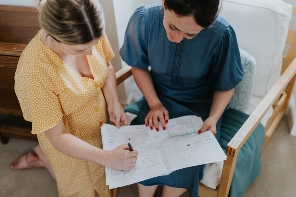 Interior Designer Looking At Room Plans - Wells and Maguire